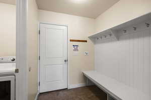 Mudroom with washer / clothes dryer and a textured ceiling