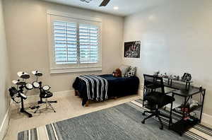 Carpeted bedroom with baseboards and ceiling fan