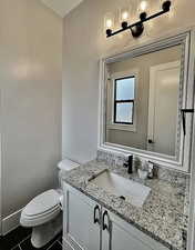 Half bathroom with vanity, tile patterned flooring, and a chandelier