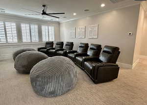 Cinema room featuring light carpet, crown molding, a ceiling fan, and recessed lighting