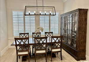 Dining space with a chandelier and light wood-type flooring
