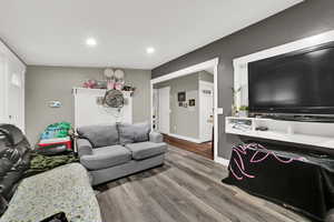 Living room featuring wood finished floors and recessed lighting