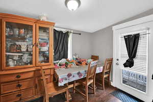 Dining area featuring a textured ceiling and dark wood-type flooring
