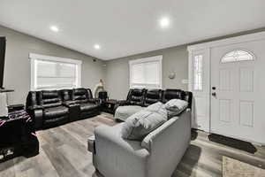 Living room with light wood-type flooring, plenty of natural light, and recessed lighting