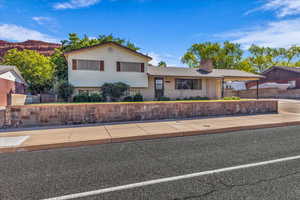 Tri-level home with brick siding and a chimney