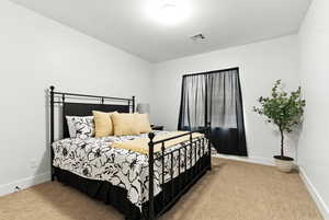 Carpeted bedroom with baseboards