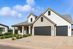 Traditional-style house featuring driveway and brick siding