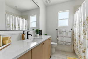 Full bath featuring vanity, tile patterned flooring, and a shower with shower curtain