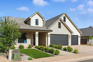 View of front of property with concrete driveway, brick siding, and a garage