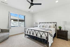 Bedroom featuring light colored carpet, recessed lighting, and a ceiling fan