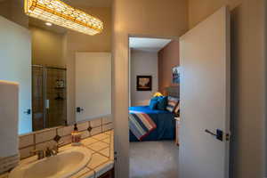 Ensuite bathroom with vanity and a shower with door