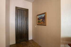 Foyer entrance featuring dark stone finish flooring