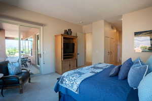 Bedroom featuring access to exterior and carpet flooring