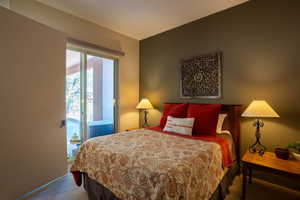 Carpeted bedroom with access to outside