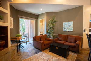 Living area featuring stone finish flooring and recessed lighting