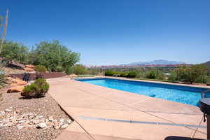 Swimming pool featuring a mountain view and a patio