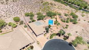 View of subject property featuring a pool and a desert landscape