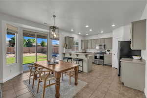 Dining area with light tile patterned flooring and recessed lighting