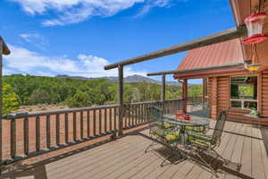 Deck with a mountain view and outdoor dining space