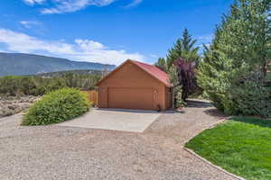 Detached 3-car garage featuring a mountain view