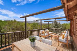 Wooden deck featuring an outdoor hangout area and a mountain view