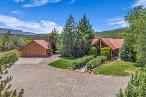 View of front of house featuring a metal roof, a mountain view, concrete driveway, and a garage