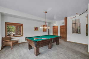 Rec room featuring carpet, billiards, and a textured ceiling