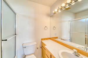Full bathroom with a shower with door and vanity