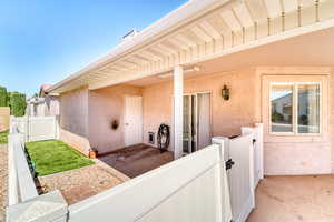 View of patio featuring a gate
