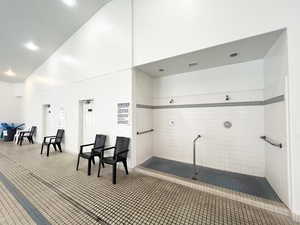 Miscellaneous room featuring high vaulted ceiling and recessed lighting