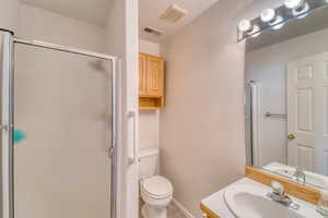 Bathroom with a shower stall and vanity