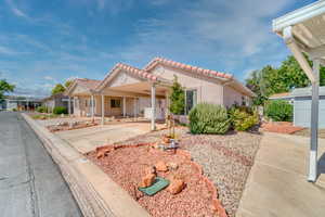 Mediterranean / spanish-style house featuring a tile roof and stucco siding
