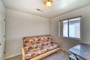 Living area with carpet and baseboards