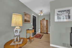 Foyer entrance featuring those gorgeous floors and a vintage chandelier.