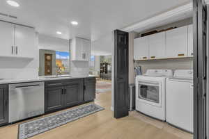Laundry just off kitchen with additional cabinetry. Washer and Dryer included.