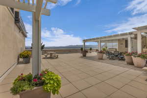View of patio / terrace featuring a pergola with bbq grill, tables lounge chairs and a expansive 360 views of the Salt Lake Valley and Oquirrh Mtns to the west.