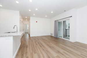 Unfurnished living room with recessed lighting and light wood-style flooring