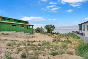 View of yard with a water and mountain view