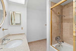 Full bathroom featuring tile patterned flooring, bathing tub / shower combination, and vanity
