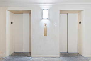 Interior space with ornamental molding and elevator