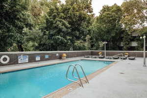 Community pool with view of wooded area