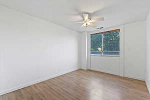 Unfurnished room featuring ceiling fan and wood finished floors