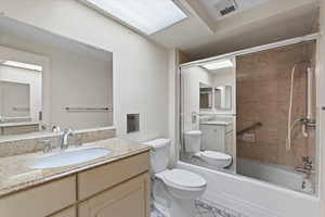 Full bathroom with washtub / shower combination and vanity
