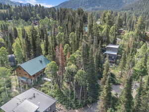 Aerial view of property and surrounding area featuring a mountain backdrop