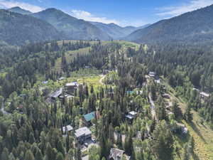 Aerial view of property and surrounding area with a mountainous background