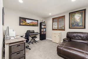 Home office featuring recessed lighting and light colored carpet