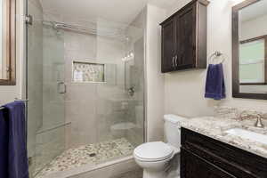 Full bathroom with vanity and a stall shower