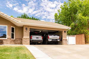 View of vehicle parking featuring concrete driveway and a garage
