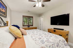 Bedroom with baseboards and ceiling fan