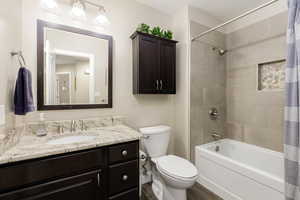 Full bath with vanity, shower / bath combo, and wood finished floors
